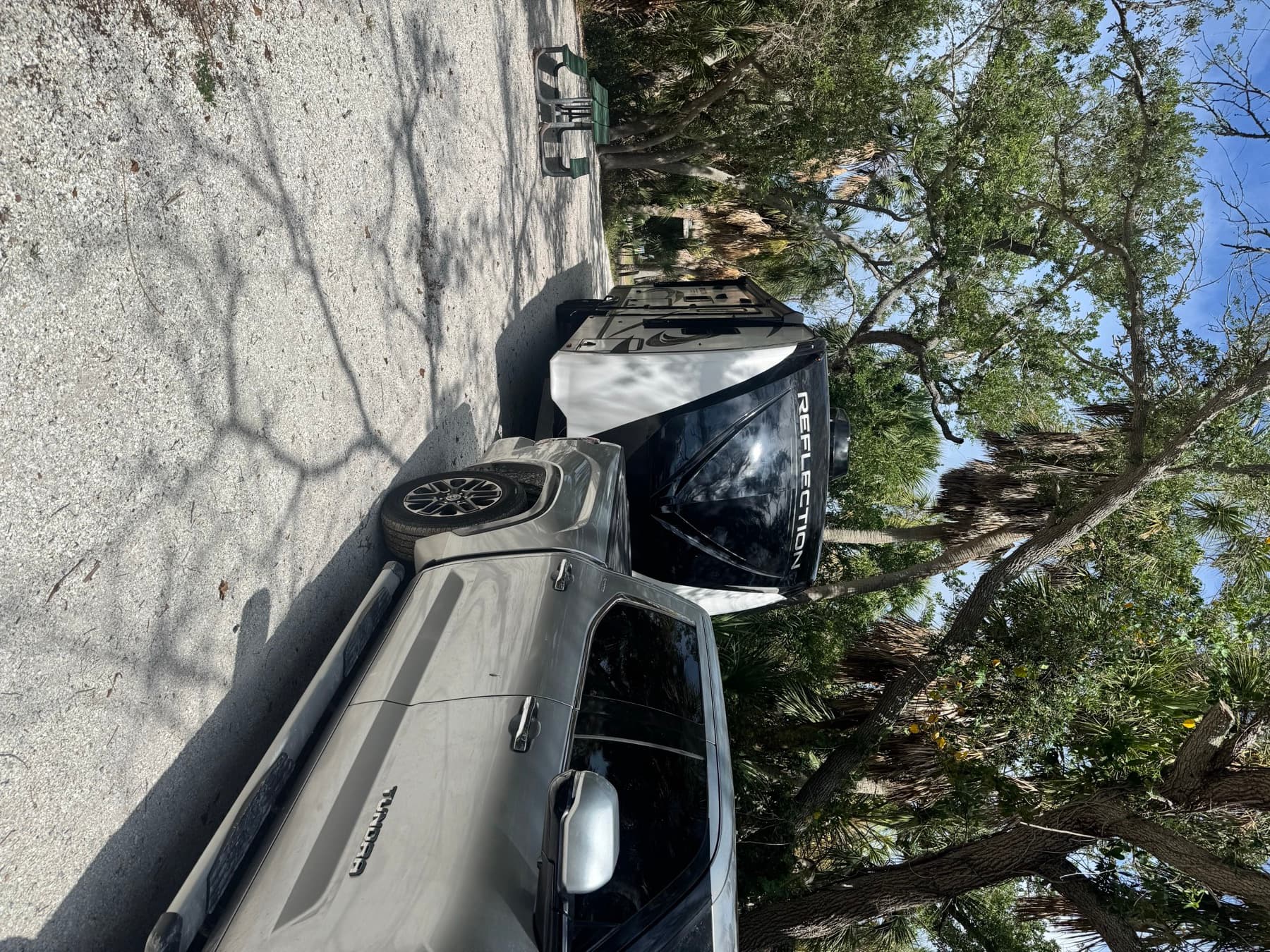 The Reflection parked at a Florida campsite under live oaks